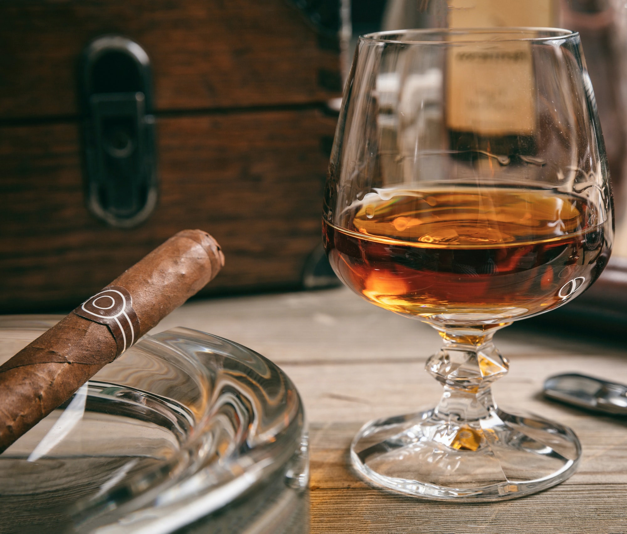 Cuban cigar in an ashtray on wooden desk