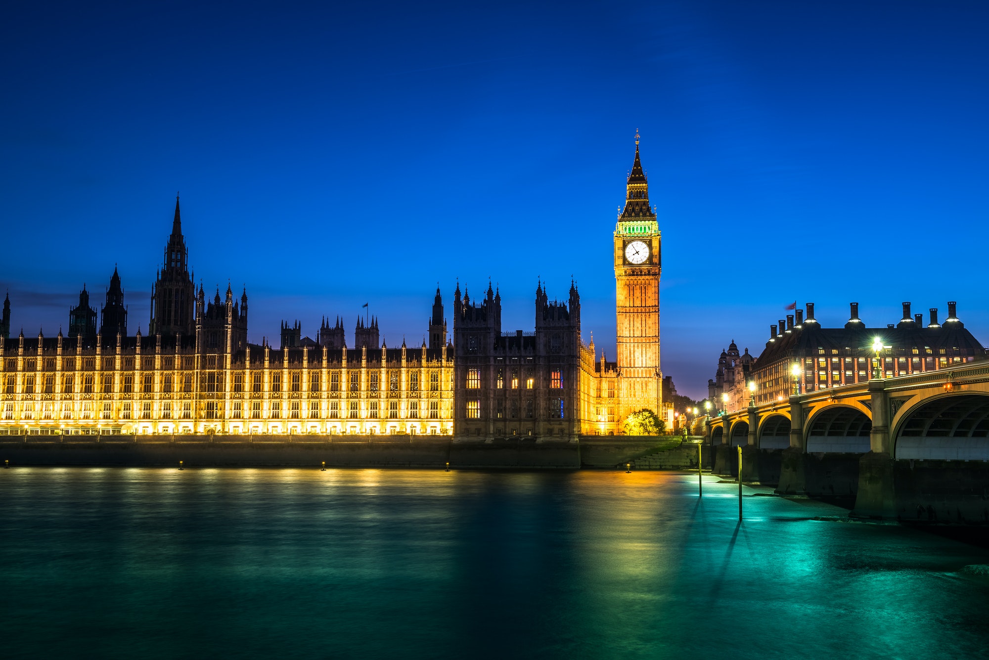 Westminster abbey and big ben in the London skyline at night, London, UK